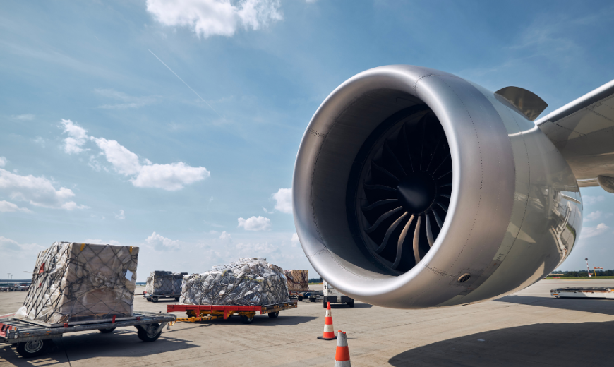 photo of plane engine with large shipments on pallets for air freight services